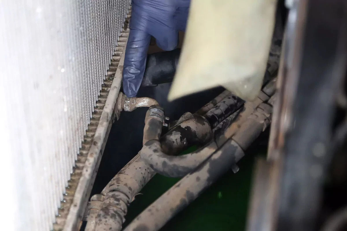 Removing the transmission cooler hose.