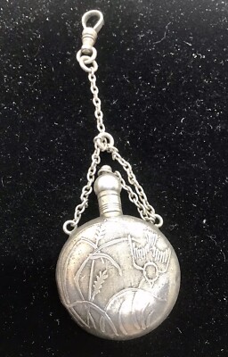 Vintage sterling silver watch fob with a embossed perfume bottle.