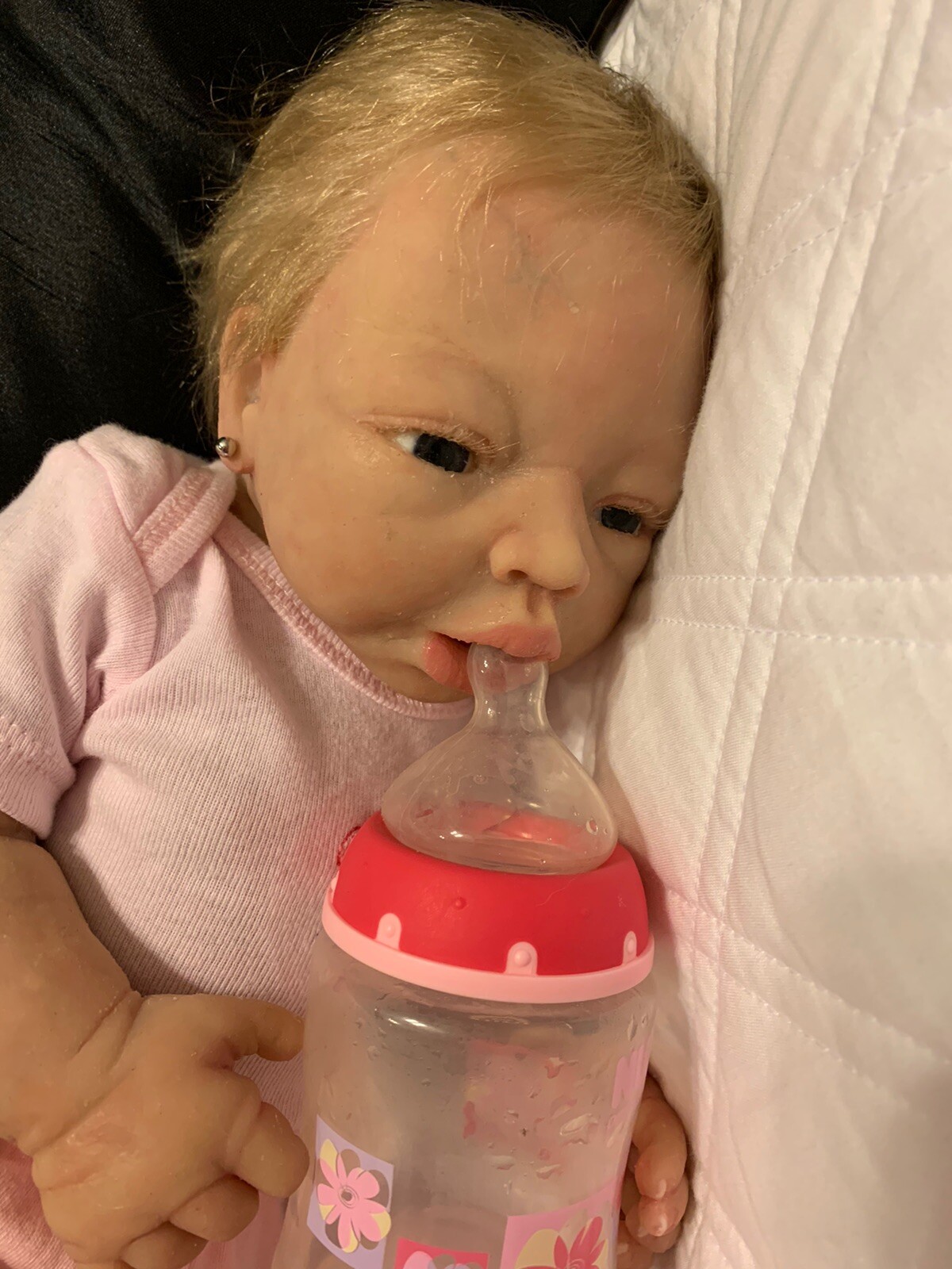 baby snuggles drink and wet doll