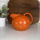 vintage RumRill Red Wing Brand 547 orange ceramic pottery ball tilt pitcher.