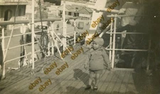 #50797 Egypt (Alexandria?) 1930s. Child in docked ship. Photo PC size RPPC