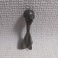 Vintage metal cap bomb toy, also known as a cap dart or cap grenade.