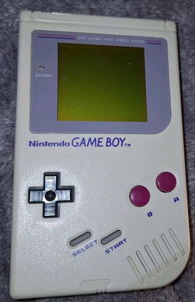 The original Game Boy DMG-01 ('the brick') with its official case — tested, working, and instantly iconic as a display piece or daily player.