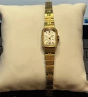Vintage Winding Woman’s Timex watch. Small Gold face with bracelet style band.