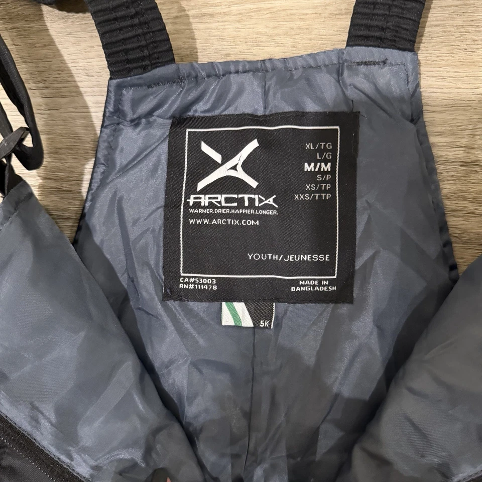 Pantalones con tirantes Arctix Youth negros aislados para esquí nieve talla mediana unisex Foto 3 de 4