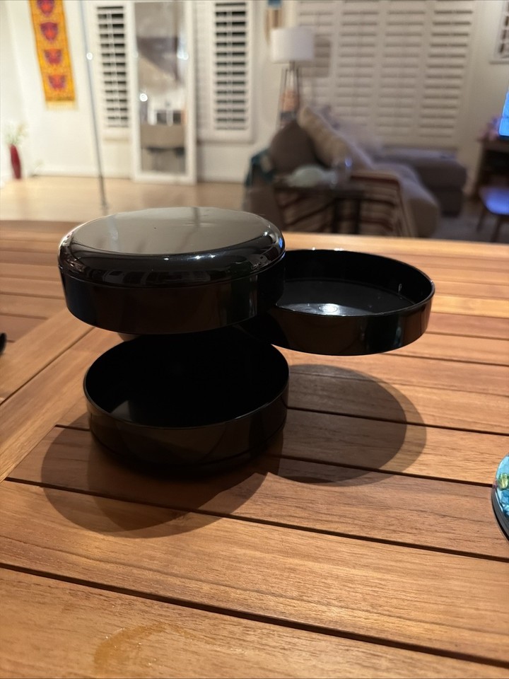 Sleek MCM swivel organizer that doubles as a jewelry/trinket caddy — the rotating design is as functional as it is retro-chic.