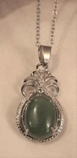 Dainty Furled Flute Topped Medium Green Oval Stone Silvertone Pendant Necklace