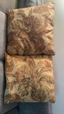 Large decorative throw pillows feature a tropical foliage pattern