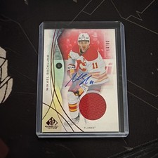 24-25 Upper Deck Sp Game Used Mikael Backlund #85 Red Auto Jersey /65 (AU, MEM)
