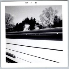Vtg B&W Snapshot Two Children Peeking Over Boat Siding Outdoor Scene 1961