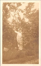 RPPC Woman Fruit Picker in Orchard Bonnet & Apron Peach Harvest c1910s Farm Life