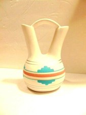 white ceramic wedding pitcher with a Southwestern painted design; EM on bottom