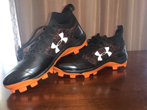 orange and black under armour baseball cleats