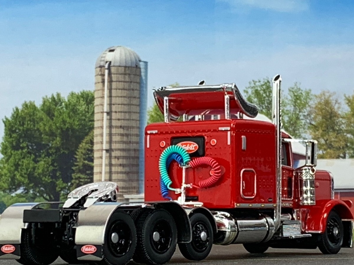 1/64 DCP RED PETERBILT 389 TRI AXLE W/ 63