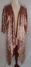 Rose gold pink velvet cover up jacket with long sleeves and draped shawl collar displayed on a dress form.