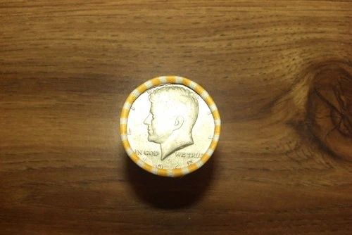 kennedy half dollar roll with a 40% silver 1968 half on end in vV- good cond.