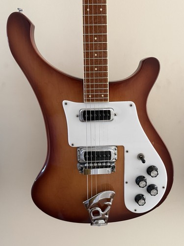 Brown 1981 Rickenbacker 480 with white pickguard, silver hardware, and three-piece sunburst finish.