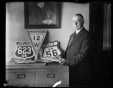 Photo:[Man with highway signs]