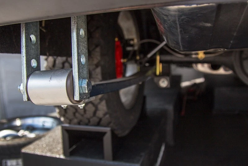The temporary rear leaf-spring shackles will be removed after the final suspension components are installed.