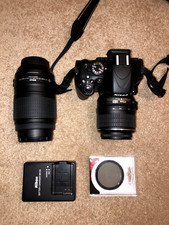 Nikon D5100 DSLR Camera With 18-55mm and 55-300mm Lenses And Charger- Black