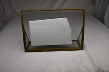 vintage-style double-sided brass and glass metal floating picture frame.