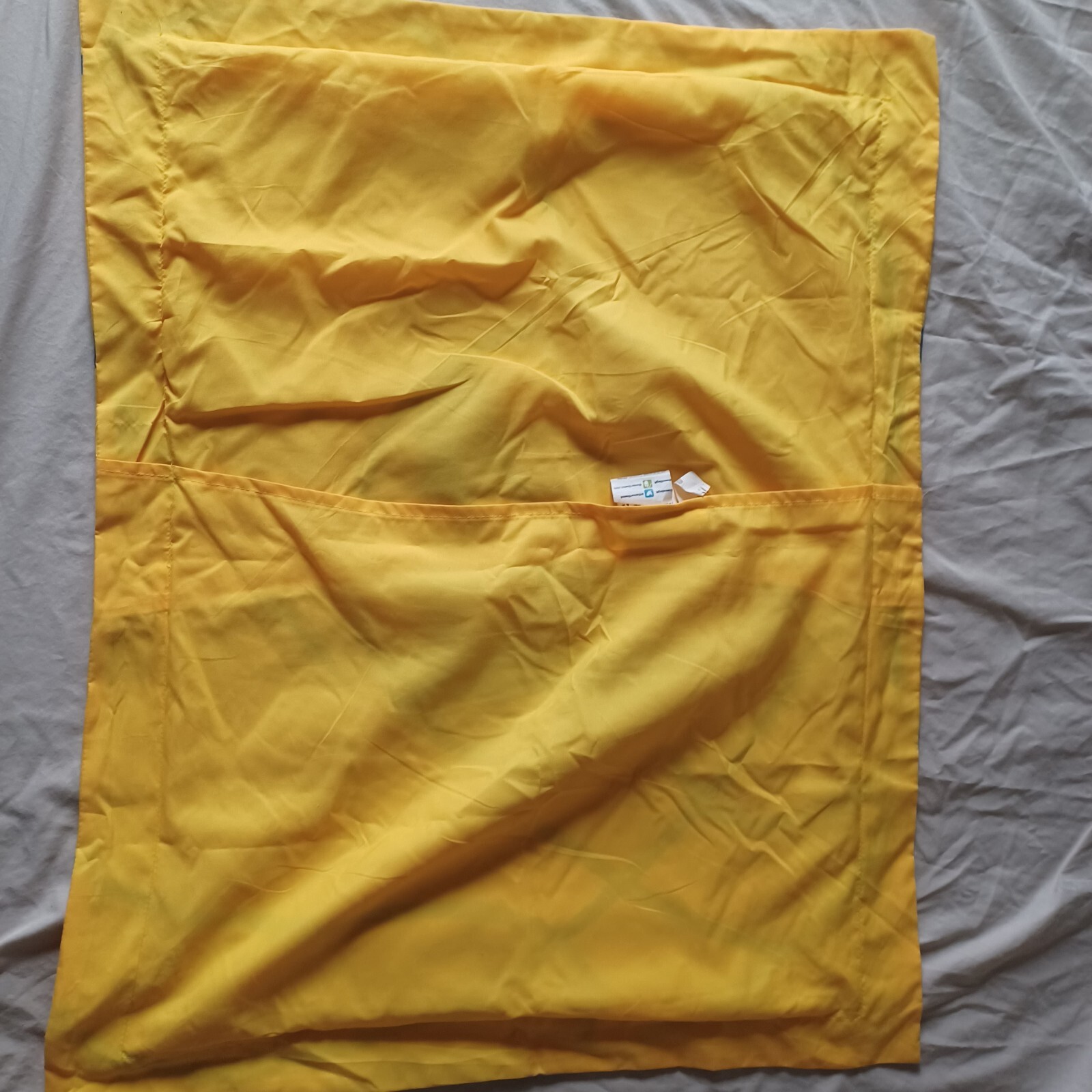 Yellow fabric Golden State Warriors NBA pillow case with 19 x 25 dimensions and a central seam.