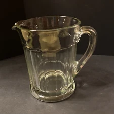 Vintage or antique heavy glass pitcher, serving beverages, ribbed design