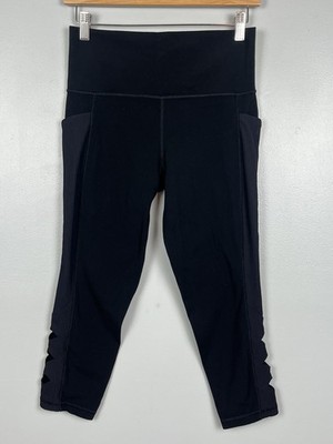 Athleta black Salutation Stash Pocket II Cutout 7/8 leggings, medium petite.