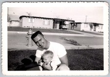 Vtg B&W Snapshot Smiling Man In White T Shirt Holding Baby On Front Lawn Circa