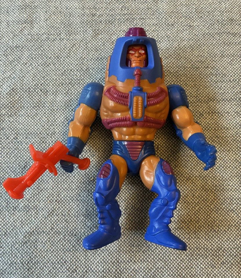 Man-E-Faces 100% complete with gun blaster — the triple-faced MOTU figure is one of the most visually wild designs of the entire line.