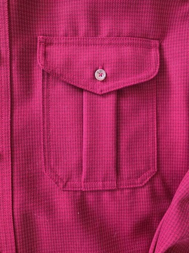 Pink Filson virgin wool shirt with two front patch pockets and a button-down collar, made in the USA.