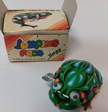 Vintage tin toy jumping frog. Tin Lithographed with googli eyes Winds up.