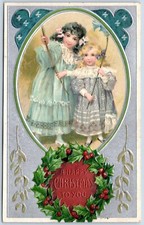 Postcard Happy Christmas Girls Pretty Dresses Holly Wreath Embossed HC15