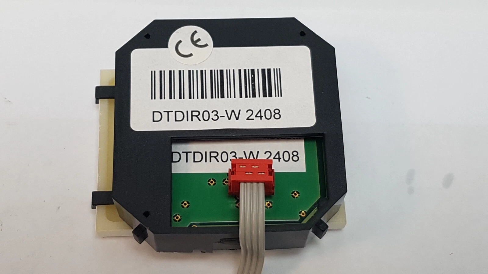 DTDIR03-W module rear label with CE mark and red ribbon connector