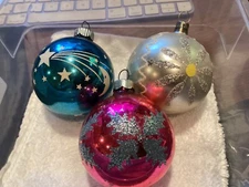 THREE 2.5 INCH BALL  SHAPED MIXED BRAND (ONE STENCIL/2 GLITTER)  ORNAMENTS