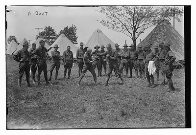 A bout,two men fighting,spectators,Signal Corps,tents,Bain News Service