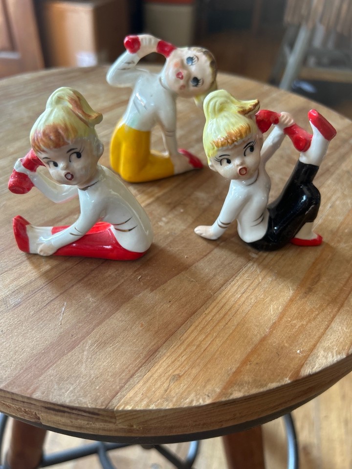 Three tiny Made-in-Japan MCM teen girl figurines with rockabilly ponytails — the kind of kitschy mid-century desk candy that stops guests in their tracks.