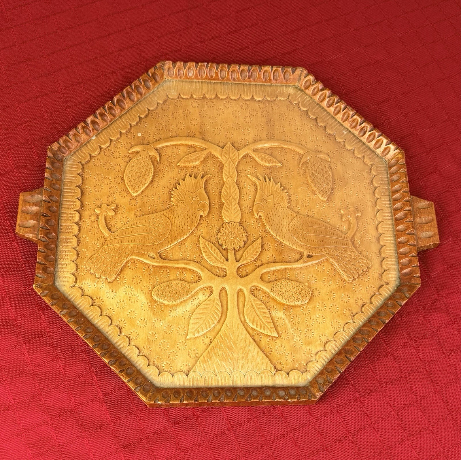 Octagonal wood tray with carved parrot design and glass insert.