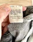 White Levi’s tag on 42x34 black jeans, gray fabric, yellow printed wash instructions and product details.