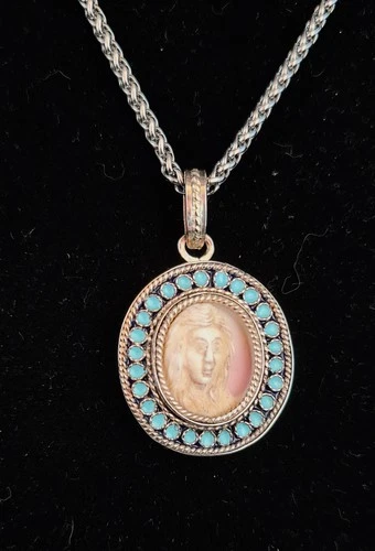 Pendant with hand carved cameo in white metal  frame with enamels.