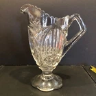 EAPG US Glass Co Banner Gloved Hand Footed Pedestal Milk Handle Pitcher