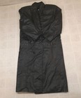 Black vintage leather trench coat with wide shoulder pads, double-breasted buttons, and notched collar on hanger.