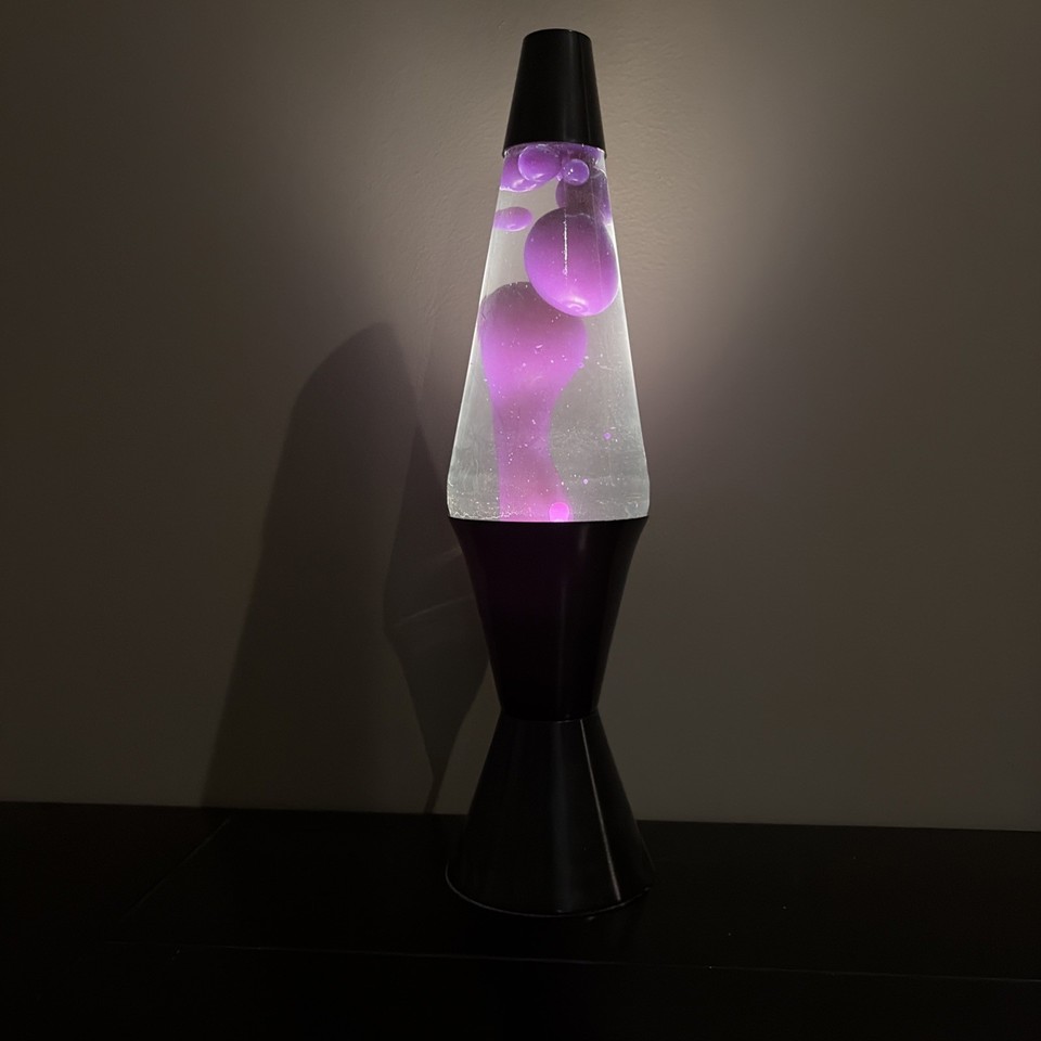 The 'Midnight' edition Lava Lite with striking purple wax in clear liquid and a sleek black base — a proper vintage statement lamp, not a knockoff.