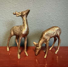 A vintage pair of solid brass deer figurines.