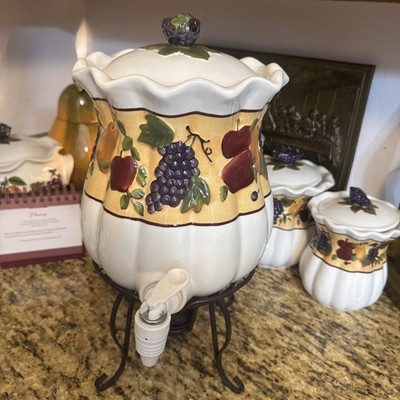 Celebrating Home Stoneware Collection Beverage Dispenser on Wrought Iron stand.