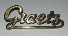 Emblem "Graetz" aus Graetz Potpourri 228 Spitzen-Phono-Super - Röhrenradio