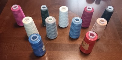 11 LARGE SPOOLS OF SEWING THREAD