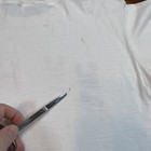 White vintage Reebok Runners t shirt with single stitch panel, subtle beige stain, and “Made in USA” text at hem.