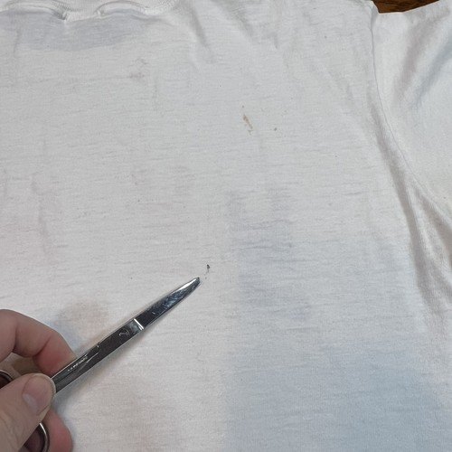 White vintage Reebok Runners t shirt with single stitch panel, subtle beige stain, and “Made in USA” text at hem.