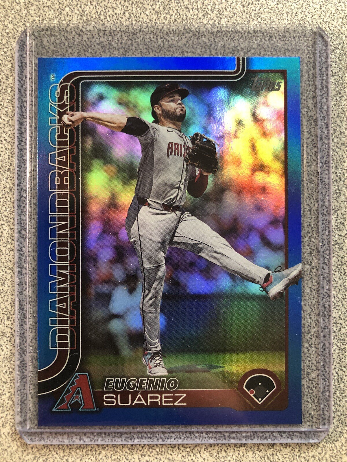 2025 Topps Series 1 #328 Eugenio Suarez Blue Rainbow Foil 011/150 Diamondbacks